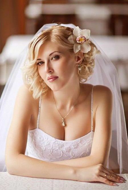 An orchid tight blonde curls bridesmaid hairstyles