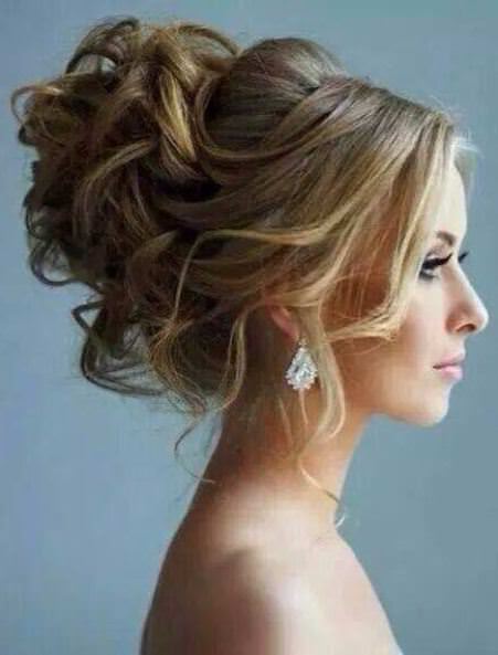 High curled bun with wispy bangs updos for curly hair