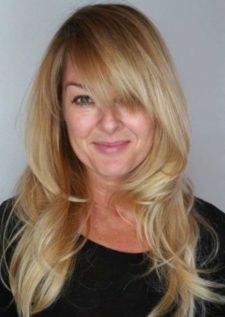 beach blonde wispy layers with high crown layered haircut with bangs
