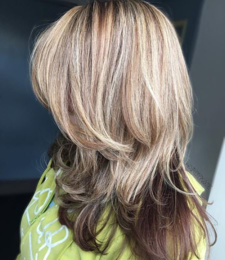 layered blonde cut with dark underlayer layered haircut with bangs