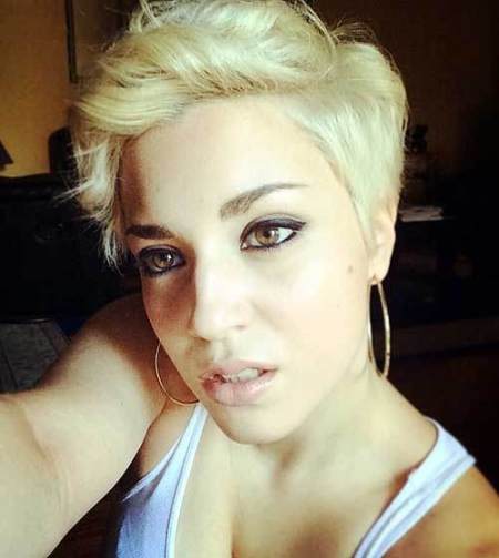 platinum blonde curly pixie with flicked back fringe wavy pixie cuts