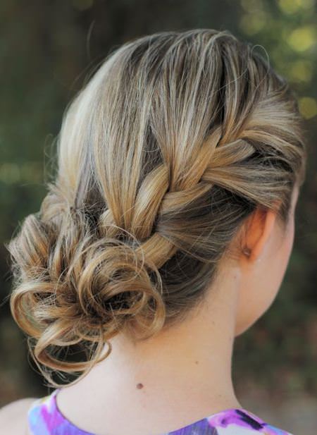 side curly bun with a side braid hairstyles for short hair