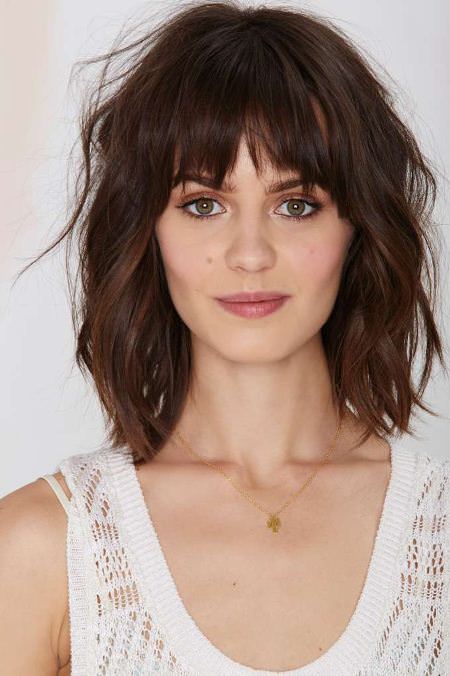 two tired fringes and tousled layers layered haircut with bangs