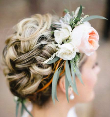 Curled floral bun hairstyles for long hair