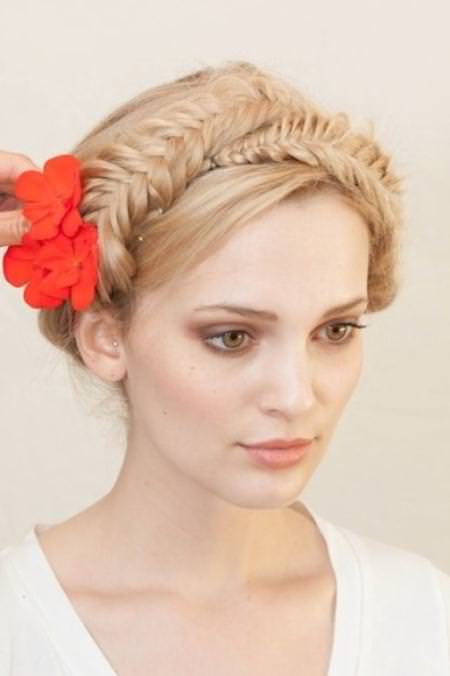 Gorgeous fishtail milkmaid braids with a red flower
