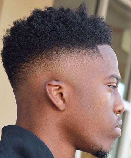 black skin fade with a high curly top curly hairstyles for black men