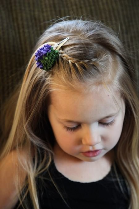 braided hairstyle with a flower clip braids for kids