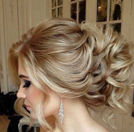 curly updo with puffy top and loose strands bridal hairstyles
