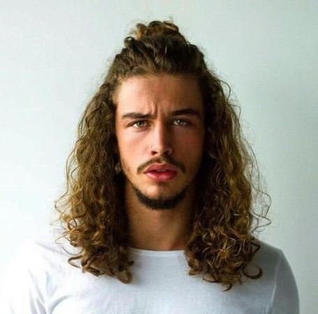 half curly topknot long hairstyles for black men