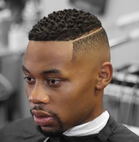 low fade haircut with a shaved side part curly hairstyles for black men