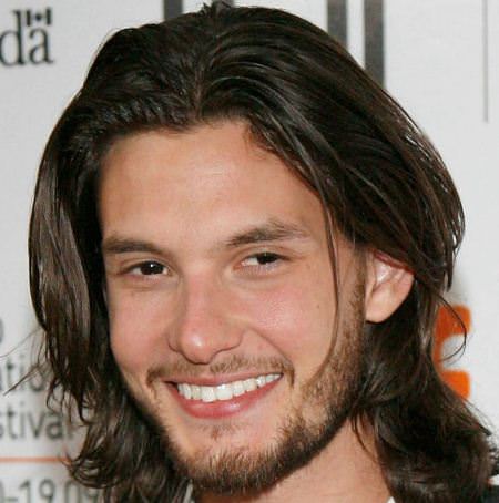 medium layered style with a middle part hairstyles for men with thick hair