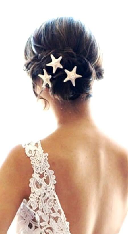 messy bun with starfish hairpins beach wedding hairstyles