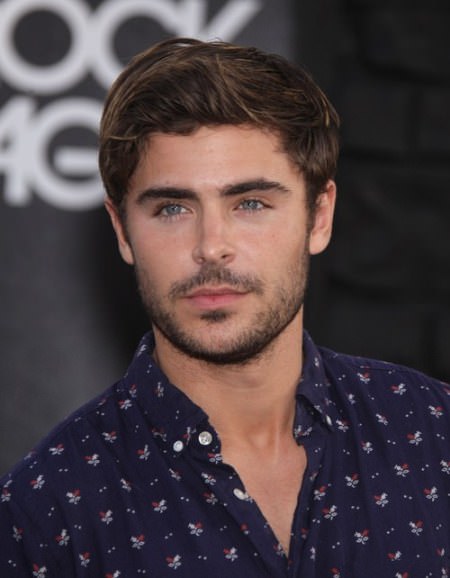 short disheveled hairstyle with a swept up quaff Zac Efron Hairstyles
