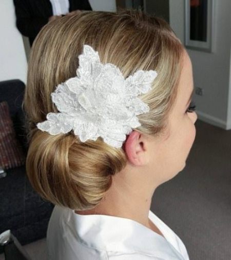 side bun with floral hair accessory side bun hairstyles