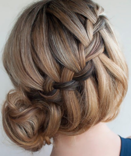 side bun with twined braid messy bun hairstyles for prom