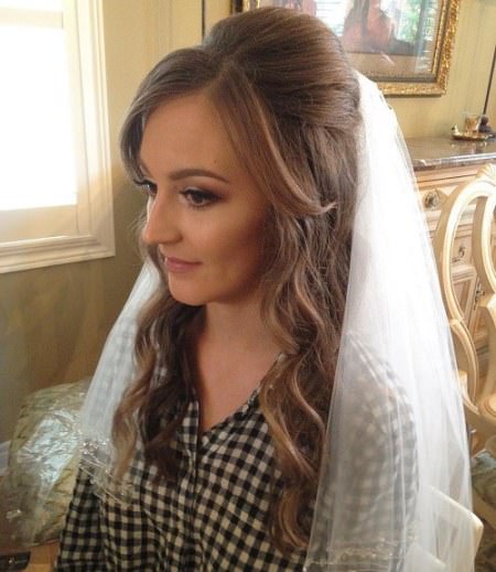 veiled bump with waves half up half down wedding hairstyles