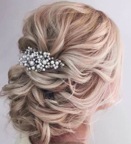 Wavy low bun with hair accessories wedding hair updos for elegant brides
