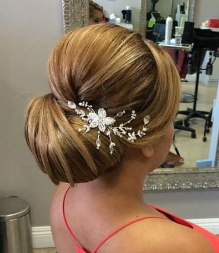 sleek bridal hairstyle with floral barrette wedding hair updos for elegant brides